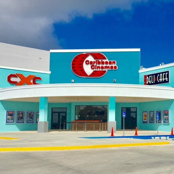 front of a turquoise movie theater