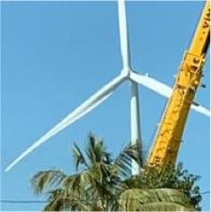 crane constructing a giant wind turbine